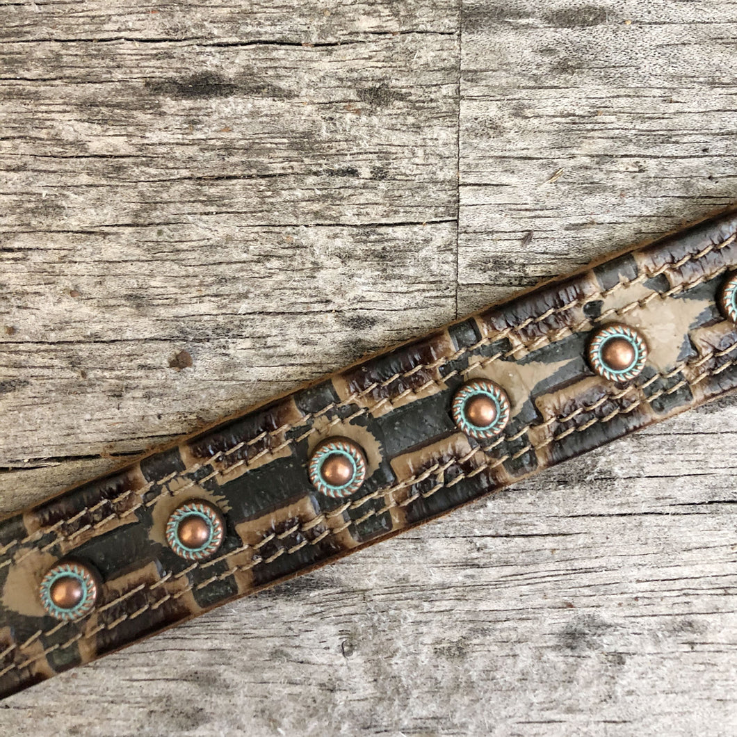 Western styled embossed leather boot bracelet with patinated copper spots.