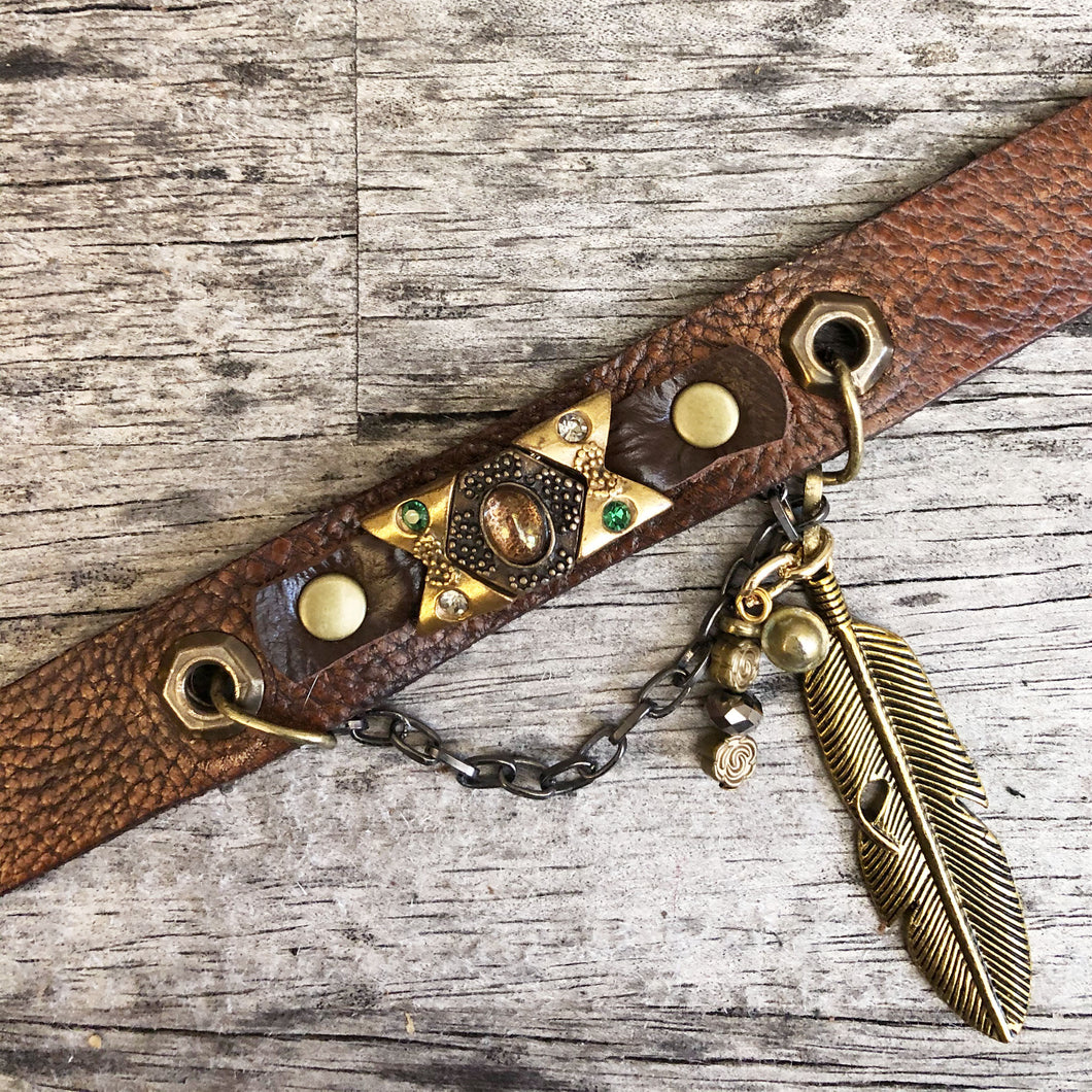 Distressed leather boot bracelet features vintage cabochon beads, crystals & charms