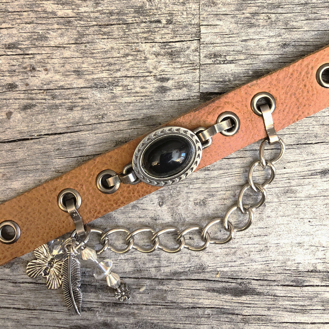 Whiskey leather boot bracelet with black cabochon style concho, chain and charms